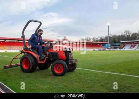 Groundsman riding tractor and maintaining football pitch at Lamex Stadium, Stevenage Football Club, Hertfordshire Stock Photo