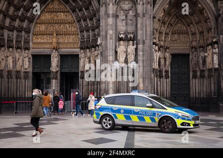 police car in front of the cathedral, Cologne, Germany.  Polizeiwagen vor dem Dom, Koeln, Deutschland. Stock Photo