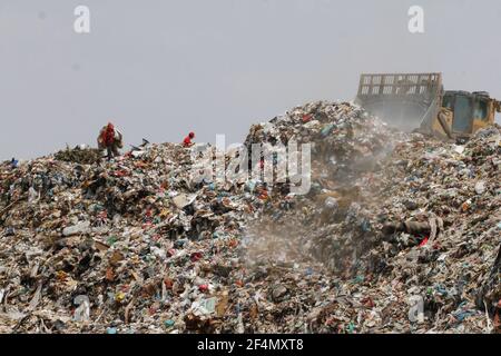 March 21, 2021, Nezahualcoyotl City, State Of Mexico, Mexico: scavengers in the Neza Bordo III garbage dump in the municipality of Nezahualcoyotl, State of Mexico, separating the trash to obtain articles that are in good condition and sell them to obtain money. One year after the start of the Covid19 pandemic in Mexico, in the waste and garbage deposit in Neza Bordo II, I in the municipality of NezahualcÃ³yotl in the State of Mexico, around 500 workers from the Urbyna PRI sector, among scavengers and collectors, perform a mass to receive the protection of Jesus Christ in health against Covid19 Stock Photo