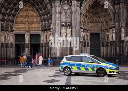 police car in front of the cathedral, Cologne, Germany.  Polizeiwagen vor dem Dom, Koeln, Deutschland. Stock Photo