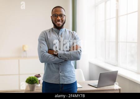 Successful African American Businessman Posing Standing In Modern Office Stock Photo