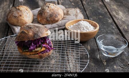 Delicious vegan burger full of vegetables made with home made sourdough bread bun. Stock Photo