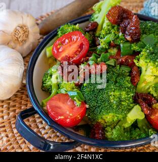 mediterranean salad with steamed broccoli florets, dry and fresh tomatoes, onion, garlic in a balsamic, olive oil dressing
