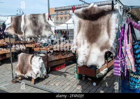 Winter clothes made from animal and Finnish Reindeer skins, on sale at an open-air market on Kauppatori (Market Square) on the main harbour front in H Stock Photo