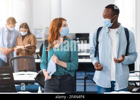 International students wearing medical masks and talking Stock Photo