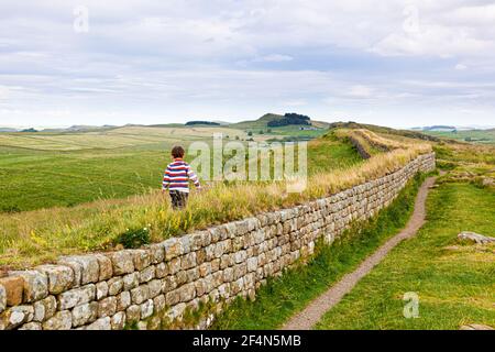 A small boy on Hadrians Wall at Steel Rig, Northumberland UK - NB Image No. C61BT4 shows his father at the same spot at the same age 31 years earlier.. Stock Photo