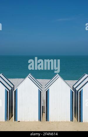 Symmetry, blue white wooden huts on the beach at Yport, Normandy Stock Photo