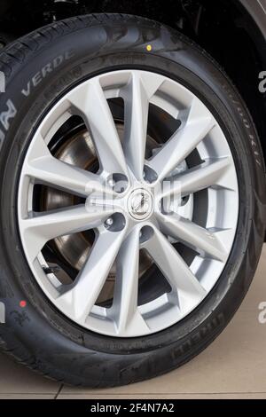 Russia, Izhevsk - February 19, 2021: Nissan showroom. The wheel with alloy wheel of a new Qashqai car. Famous world brand. Stock Photo