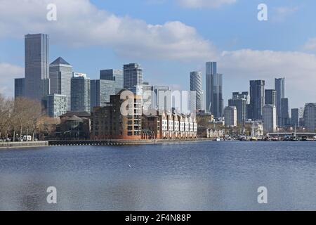 Waterfront housing in Greenland Dock, Rotherhithe, London, UK. Part of the  old Surrey Docks redeveloped in the 1980s. Canary Wharf towers beyond. Stock Photo