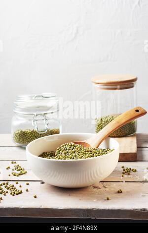 Raw mung beans in a bowl on a wooden table. Stock Photo