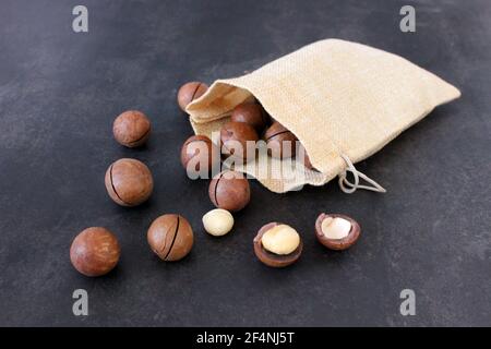 Organic Macadamia nut on dark table Stock Photo