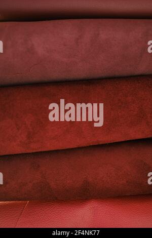 Genuine leather texture.Red leather and suede in rolls set.Leatherworking. Genuine leather red background.Manufacturing from genuine leather.Hobby and Stock Photo
