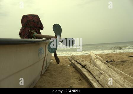 Three Blade motor boat engine propeller fitted on a small fishing boat parked at sea shore Stock Photo