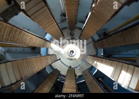 View of part of huge industrial machine or other equipment in the form of pipe with long wooden details inside making perspective Stock Photo