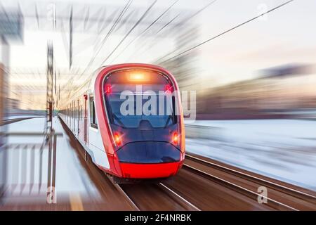 High speed modern commuter train red lights, motion blur Stock Photo