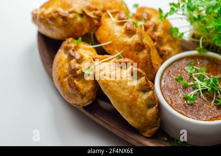 Mini pasties with tomato sauce, succulent pork, turkey, bacon and cranberry all wrapped in shortcrust pastry, tasty food Stock Photo