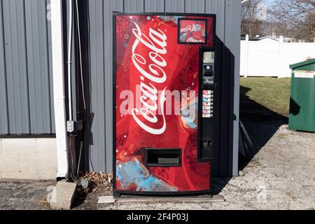 Muncie - Circa March 2021:  Coca-Cola vending machine. Coca-Cola manufactures Coke, Diet Coke, Sprite, Dasani, and various Coke coffee products. Stock Photo