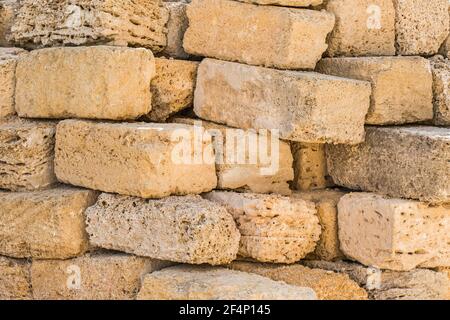 Heap of brick shell blocks sand stone texture background, close-up. Stock Photo