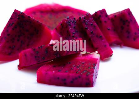 Juicy cut fruits of edible dragon fruit cactus, pitahaya - on white background, texture close up Stock Photo