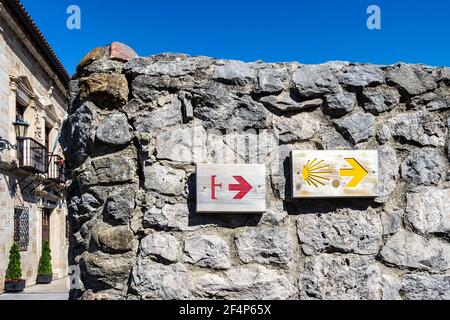 Hearts on Yellow Arrow Marking Sign on St James Way, Camino de Santiago Trail near San Vicente de la Barquera. Way of St. James, Cantabria, Spain. Stock Photo