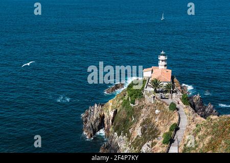 Landscape of the Cantabrian sea and the lighthouse of Cudillero, a typical coastal town of Asturias that is located in the north of Spain