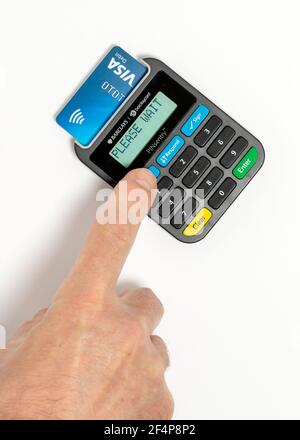 Barclays Pinsentry card reader device and man's finger pressing button for identification. Stock Photo