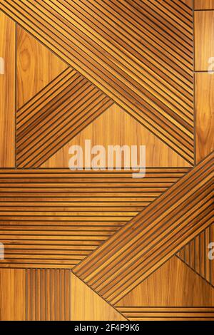 Designer walnut veneer panel, geometric crisscross pattern wood wall. Architectural background, texture. The concept is a modern interior, natural mat Stock Photo