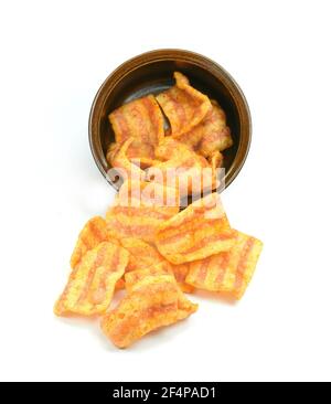 Bowl of bacon-flavored puffed wheat chips. Bacon Chips. Delicious bacon snacks isolated on white background. Pelleted salted snack bacon. Smoked bacon Stock Photo