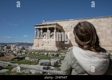 Athens, Greece. 22nd Mar, 2021. A woman visits the archeological site of Acropolis in Athens, Greece, on March 22, 2021. On Monday, open-air archeological sites, including the Acropolis hill in Athens, reopened for the first time since the start of the lockdown. Only a small group of visitors is allowed to visit and the use of protective face masks is obligatory. Credit: Lefteris Partsalis/Xinhua/Alamy Live News Stock Photo