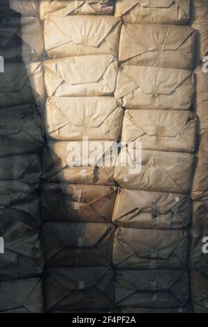 Vertical shot of weathered packages wrapped in brown paper and stacked. Stock Photo
