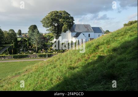 Romanesque Jelling kirke (church) built in 1100. The royal seat of first kings of Denmark with large stone ship, two large burial mounds, the Jelling Stock Photo