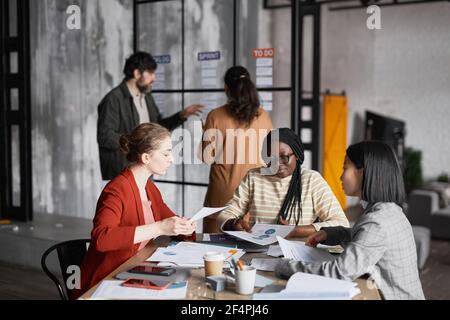 Diverse group of business people working in office together Stock Photo