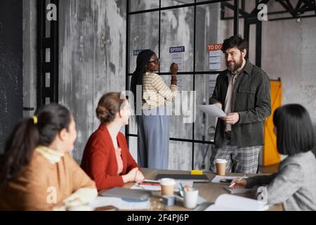 Diverse group of business people collaborating in modern office Stock Photo