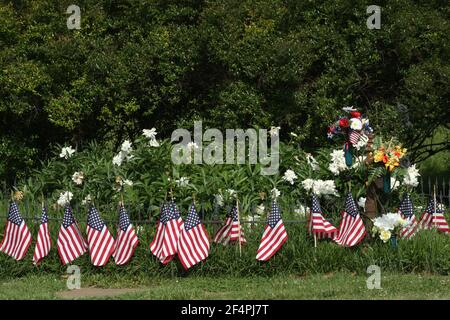 Tomb covered in flowers and surrounded by U.S. flags Stock Photo
