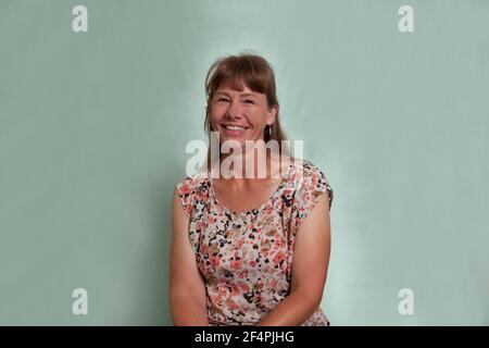 Middle aged caucasian woman with dark blond hair smiling and laughing Stock Photo