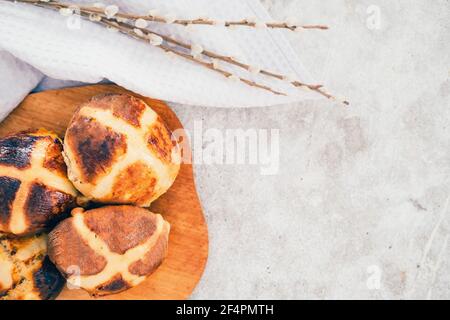 Traditional British Easter buns on a wooden plank. Stock Photo