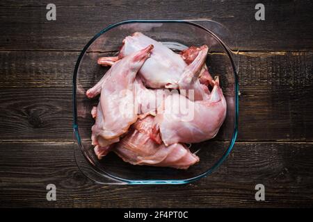 Raw rabbit meat marinated in glass bowl. Selective focus. Stock Photo