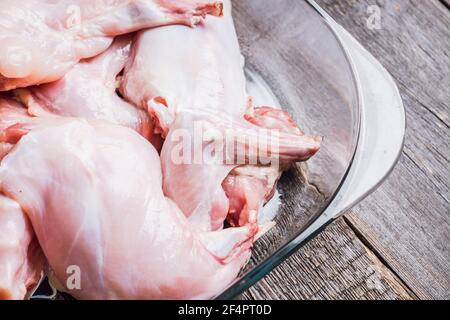 Raw rabbit meat marinated in glass bowl. Selective focus. Stock Photo
