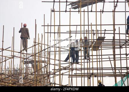 Workers at the housing construction site with wooden Framework construction, BEIJING, CHINA - 26TH OCT 2015. Stock Photo