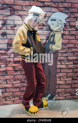 Japanese female dressed in as Maka Albarn with Soul Eater Scythe poses in  front of image of her anime character, Tokyo International Anime Fair,  Japan Stock Photo - Alamy