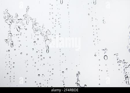 Water Drops Background. Macro view of icy rain drops on the window creating abstract geometric graphic shapes. Close Up Stock Photo