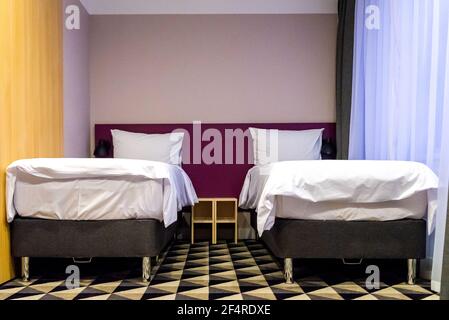 Hotel room with two double beds with pillows Stock Photo