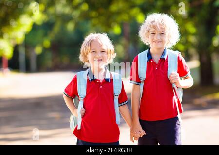 Children go back to school. Start of new school year after summer vacation. Boy and girl with backpack and books on first school day. Beginning of cla Stock Photo