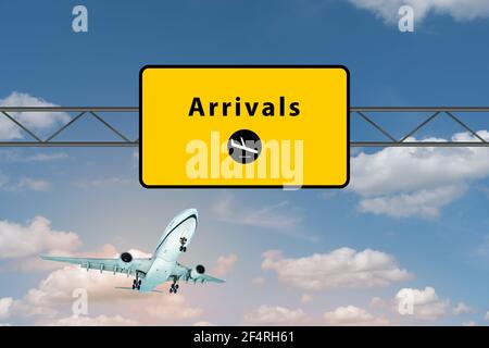 Arrivals airport sign above highway. Landing airplane in the sky. Stock Photo