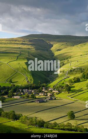 Scenic Dales village (houses) nestling in valley by dry-stone walls, hillside slopes & steep-sided Cam Gill gorge - Starbotton, Yorkshire England, UK.