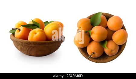 Ripe apricots isolate on a white. Two bowls with apricots with leaves isolated on white background. Ripe apricots with copy space for text. Fruit on w Stock Photo