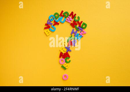 Alphabet forming a question mark on a yellow background Concept of education and knowledge Stock Photo