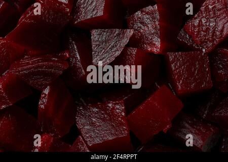 Fresh beet cubes on whole background, close up Stock Photo