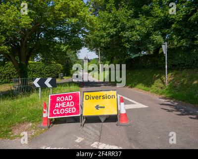A road ahead closed and diversion sign on a country lane in a rural setting at Wrington, North Somerset, England. Stock Photo