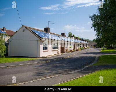 Retirement bungalows with solar panels fitted to the roofs in the rural village of Wrington, North Somerset, England. Stock Photo